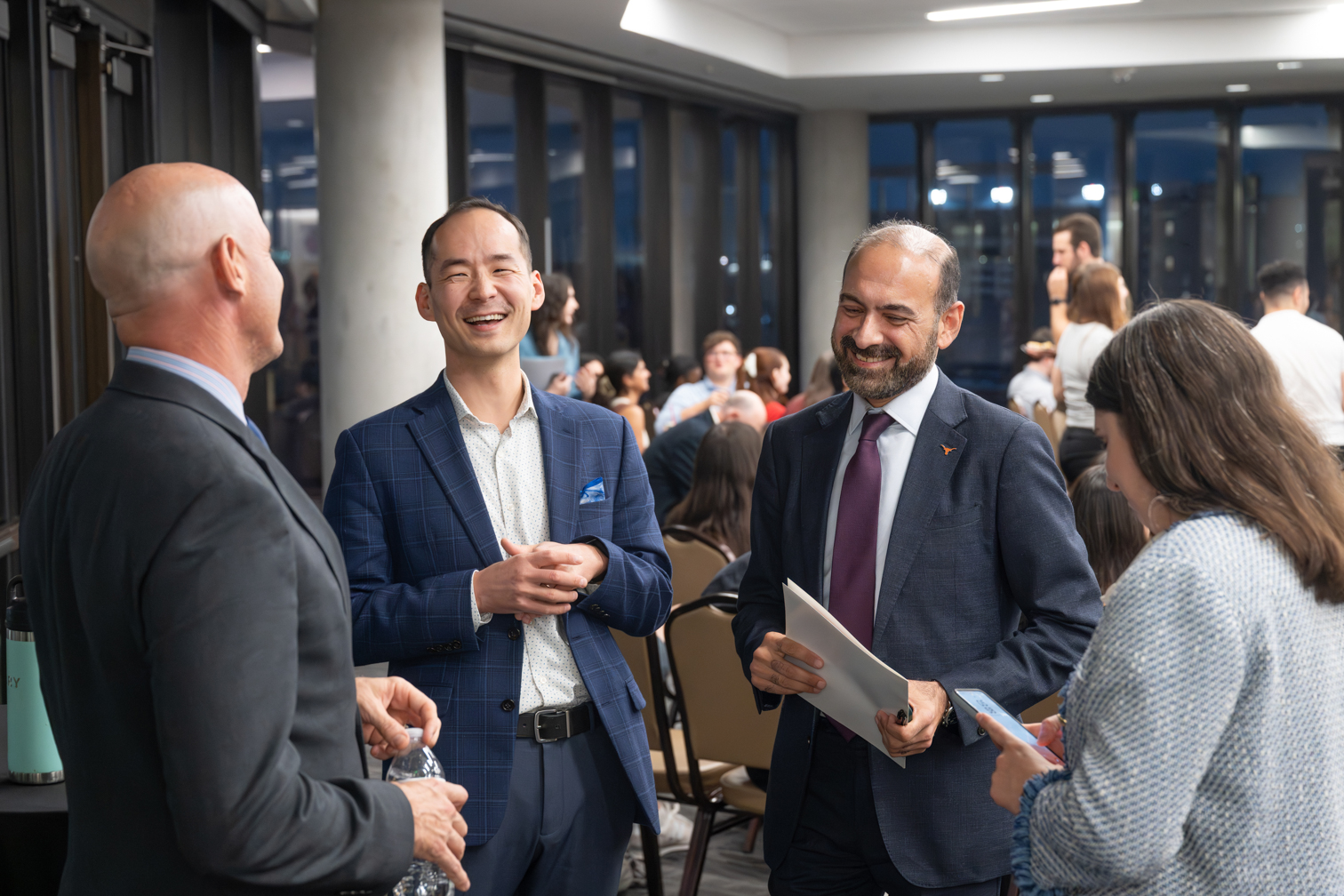 Dilawar Syed in conversation with colleagues at a policy event